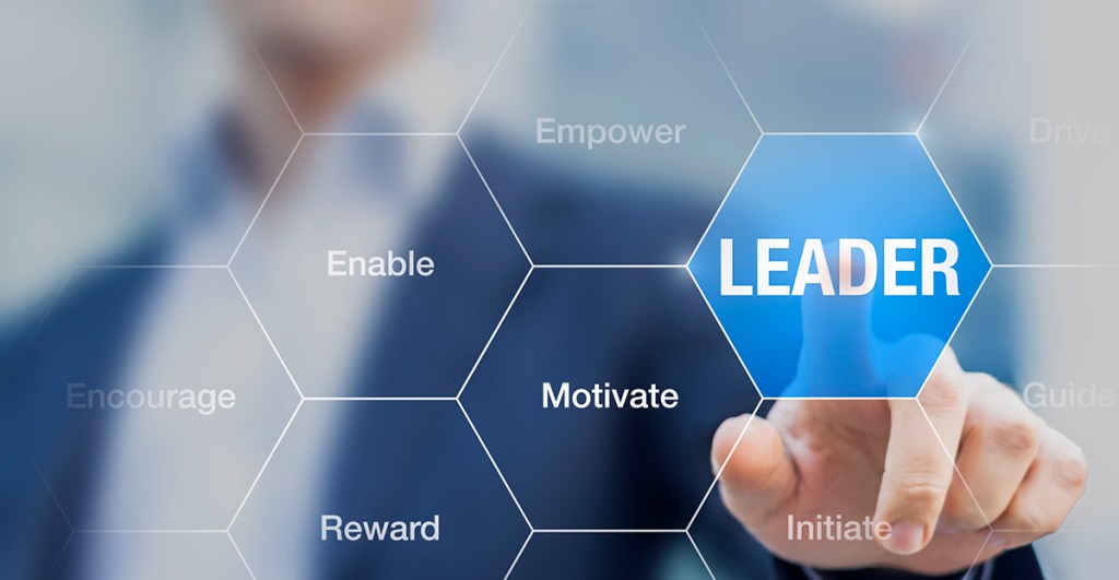 man with finger pointing to word leadership