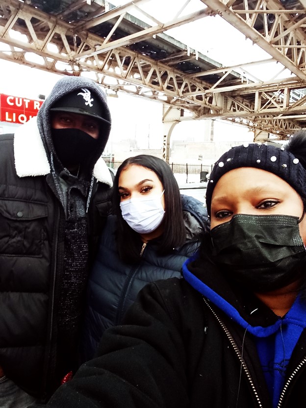 Trina, a lady and a man stop for a photo