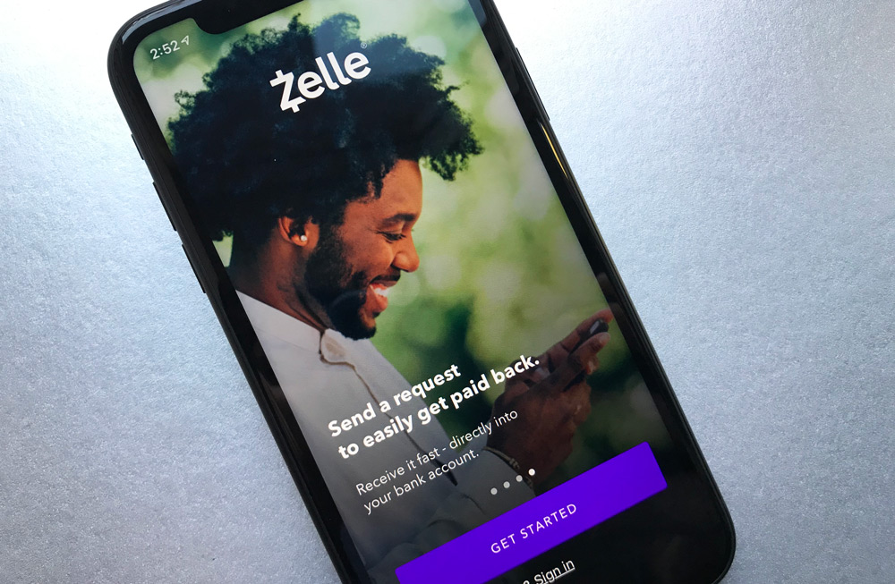 zelle, image of man, smiling looking down at his cellphone